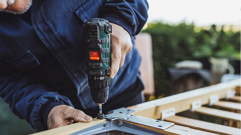 a-man-works-on-a-wood-project-in-a-home-garden_original